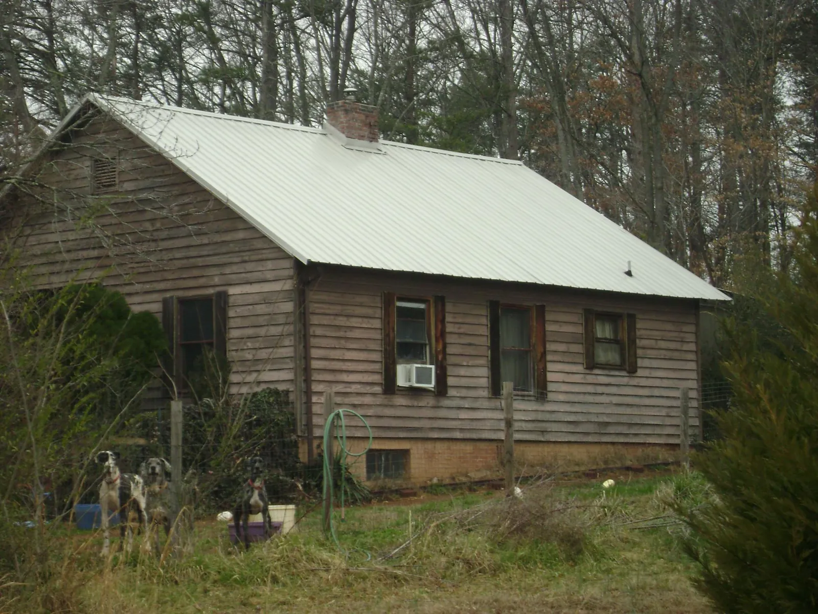 White metal roof on an old wood sided farmhouse, from a Metal Roof Installation job in Stockett